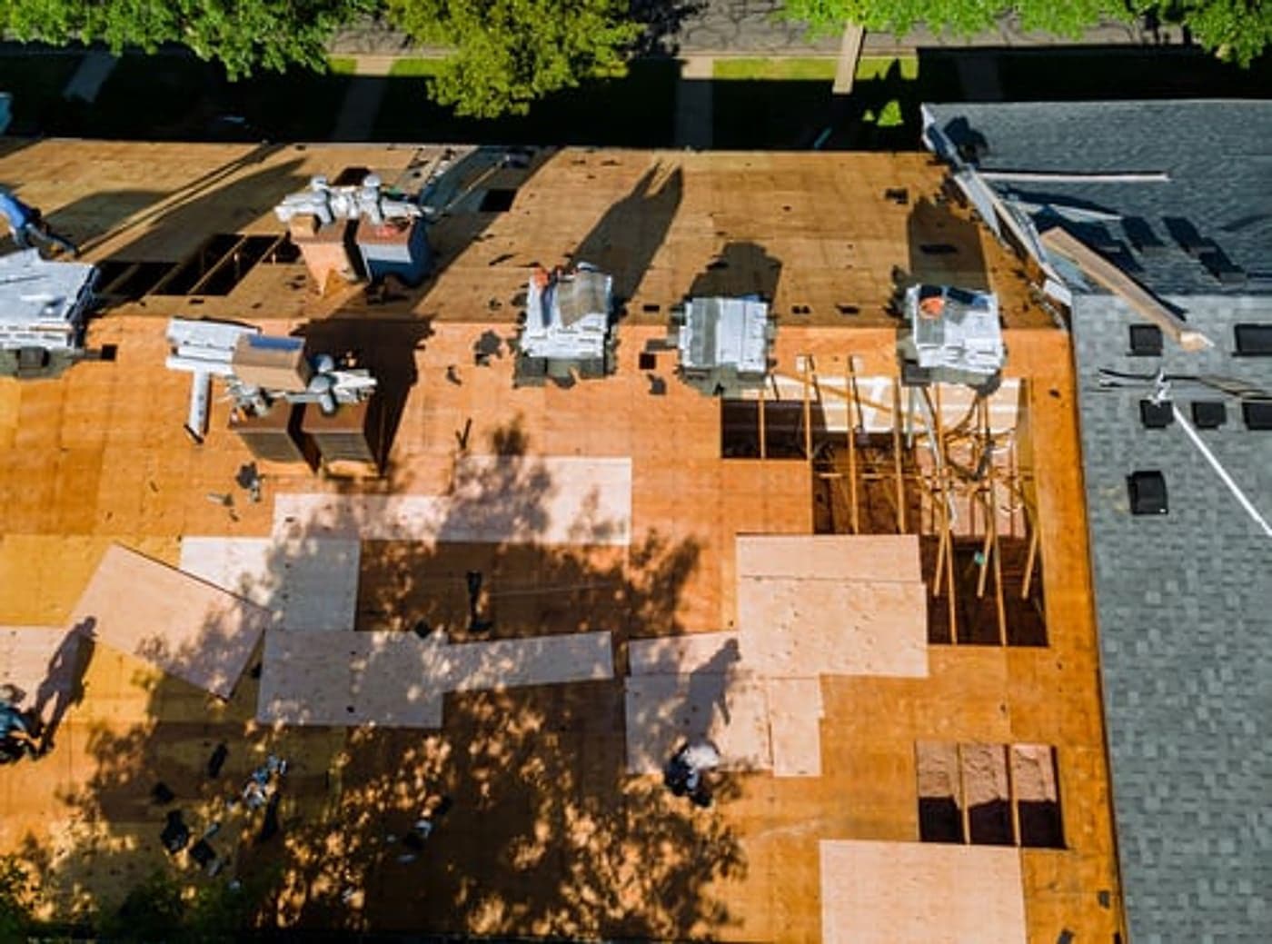 Aerial view of a G&I B Construction crew re-decking a residential roof