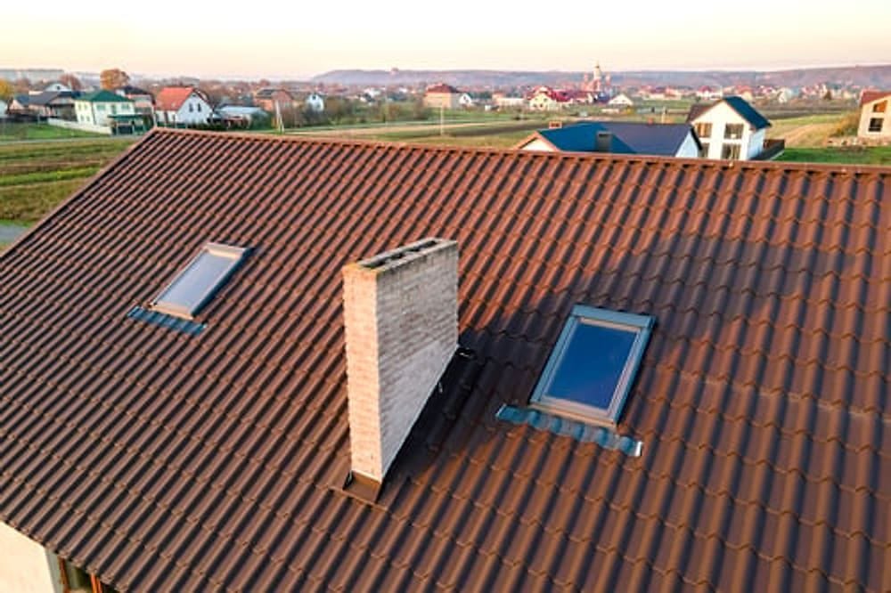 Newly installed tile and shingle roof on a Southern Indiana home completed by G&I B Construction